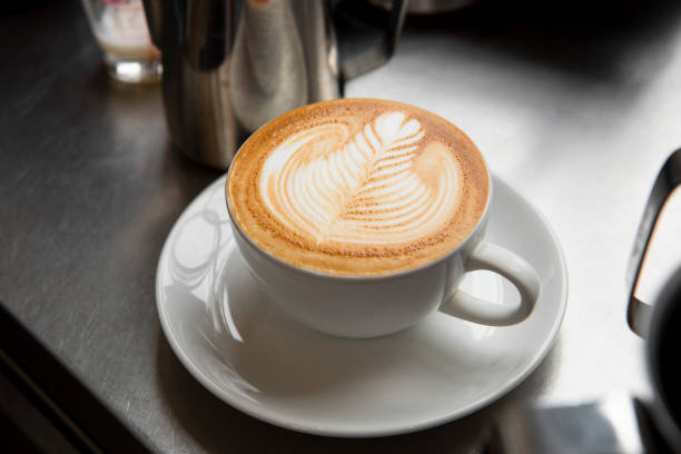 istock latte or Cappuccino with frothy foam, coffee cup top view on table in cafe. 1036787134