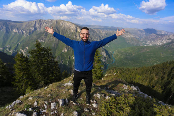 istock Happy young man on a mountain top 1036787916