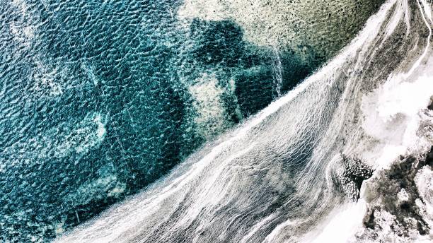 Icy water by the shore stock photo
