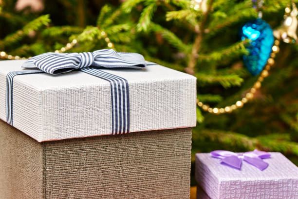 istock Gift boxes with bows on the lids under a Christmas tree in New Year Eve 1036795352