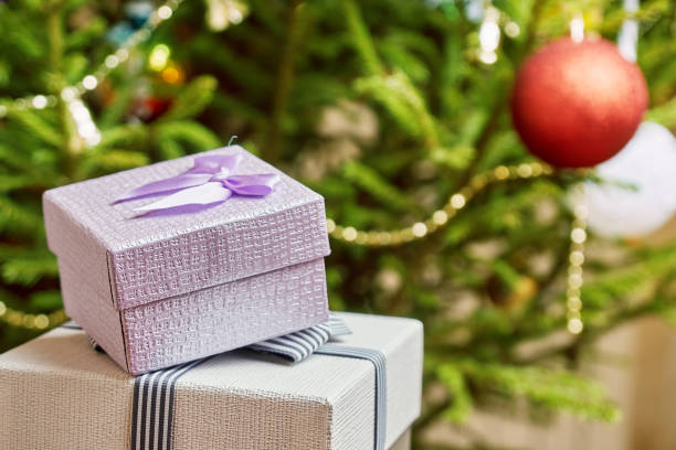 istock Gift boxes with bows on the lids under a Christmas tree in New Year Eve 1036795360