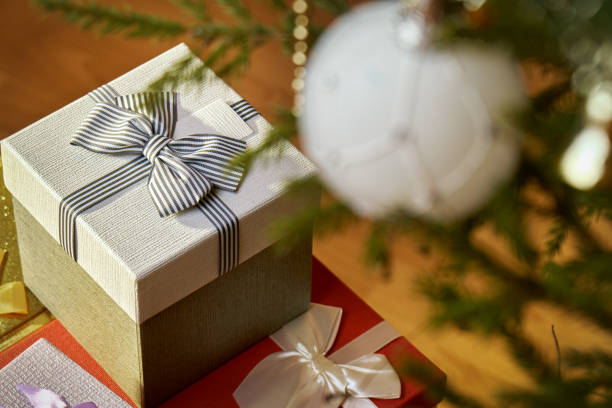 istock Gift boxes with bows on the lids under a Christmas tree in New Year Eve 1036795538