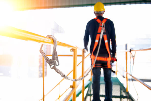 Construction worker use safety harness and safety line working on a new construction site project. Construction worker use safety harness and safety line working on a new construction site project. safety harness stock pictures, royalty-free photos & images