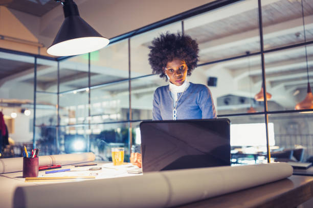 istock Young African-American woman architect working on a project. 1036803286