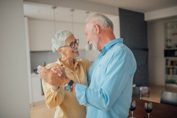 istock Husband and wife dancing at home 1036808370