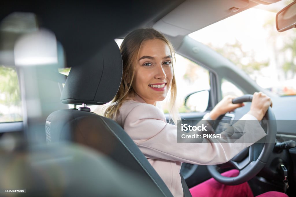 Woman driving a car Young woman sitting in a car Car Stock Photo