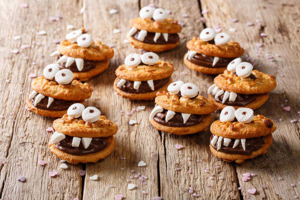 istock Halloween Dessert: funny monsters from cookies close-up. horizontal 1036810658