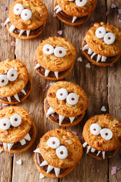 istock Peanut biscuit monsters for Halloween close-up on the table. vertical view from above 1036814184