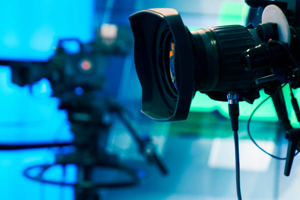 istock Broadcast television studio camera and crane camera in news studio room with LED lights 1036815050
