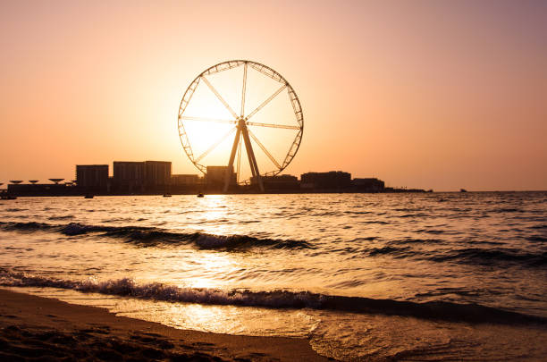 istock Jumeirah Beach Resort beach with Dubai ferris wheel 1036815826