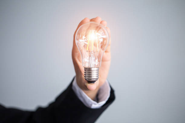 istock Business man holding light bulbs, ideas of new ideas with innovative technology and creativity. 1036824408