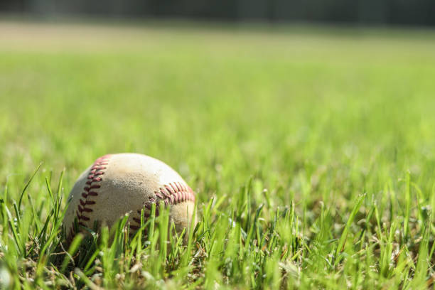 istock Baseball season is here.  Weathered ball on field. 1036826340