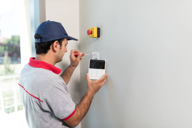 Man installing security alarm system Technician set up keypad of security alarm system fire alarm photos stock pictures, royalty-free photos & images