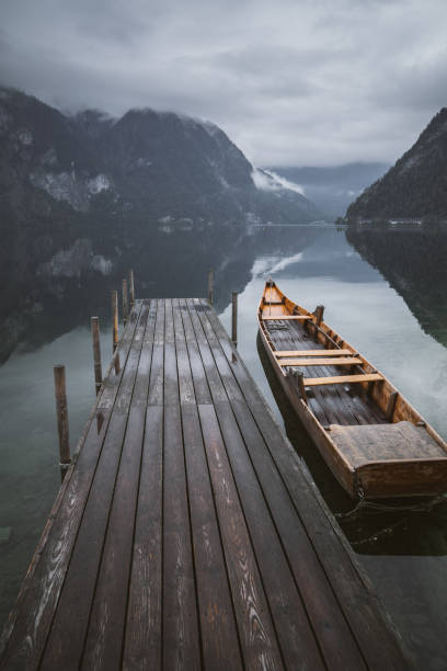 steps into a turquoise lake and wooden boats reflections on the water