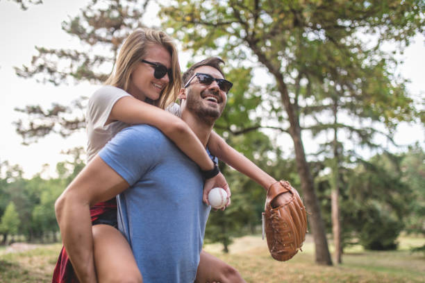 istock Gorgeous couple having fun playing baseball together in a forest 1036836474