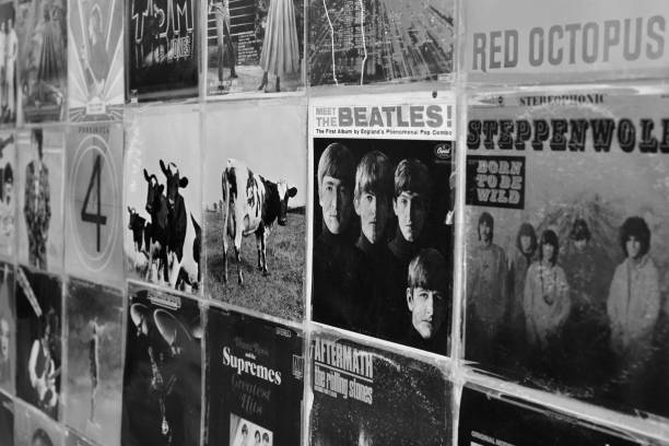 Athens, Greece - August 29, 2018: Wall with vintage vinyl records pop and rock music album sleeves background. Selective focus black and white.