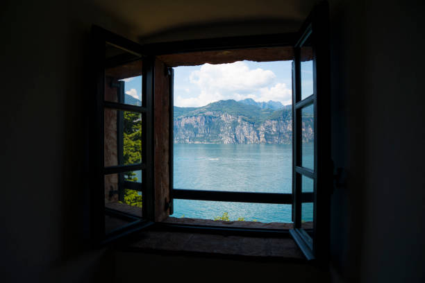 Window on Lake Garda (Italy), a holiday area appreciated by many European tourists. Lake panorama seen through a window.