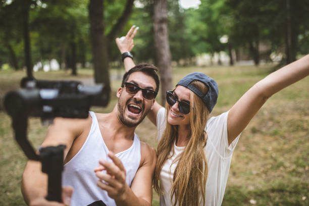 istock Cute couple filming a vlog in a forest 1036850510