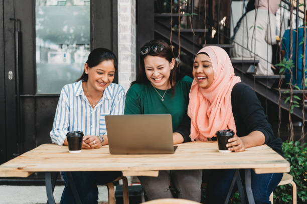 Friends doing a conference call together Friends doing a conference call together. Malaysian, indian and chinese ethnicity. small business malaysia stock pictures, royalty-free photos & images