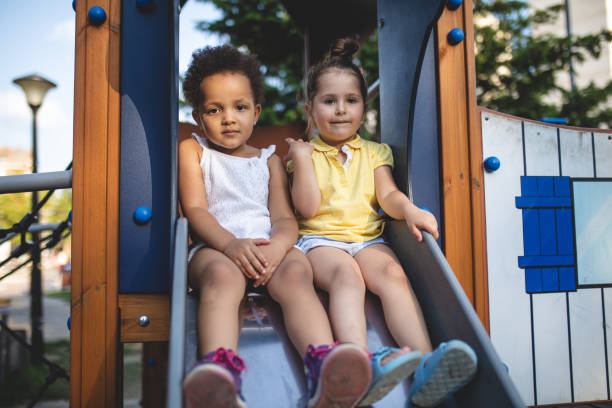 istock Serene children sitting on a playground slide 1036860280