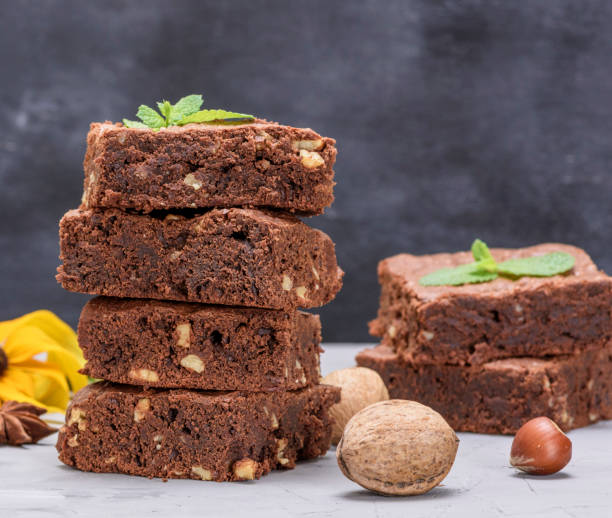 istock stack of baked square pieces of chocolate brownie pie with walnuts 1036863392