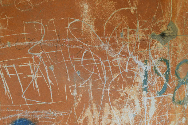 istock Numbers and symbols scratched on weathered wall 1036869322