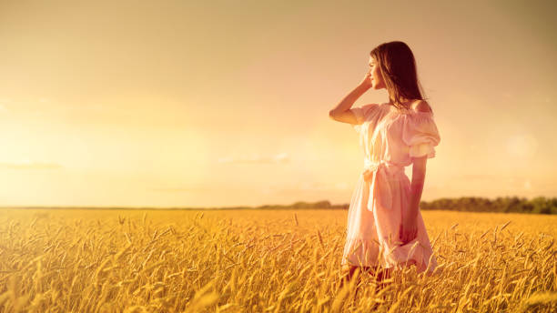 istock Young girl in wheat field 1036870144