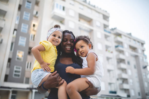 istock Lovely mother holding her mixed race children 1036873452
