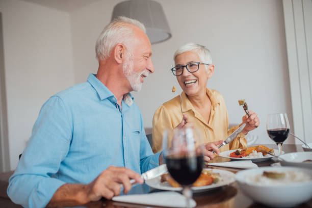 istock Happy old couple eating at home 1036881720