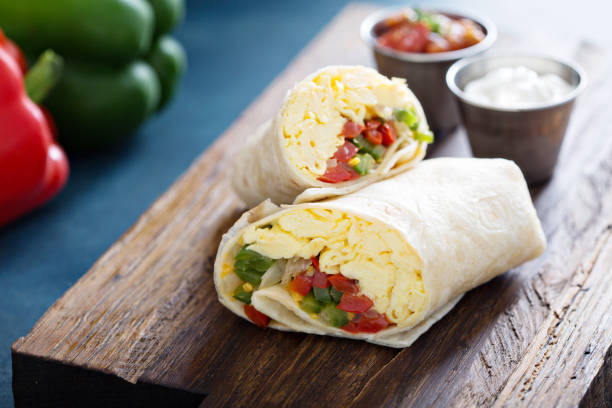 Vegetarian breakfast burrito with eggs Vegetarian breakfast burrito with eggs and bell pepper burrito photos stock pictures, royalty-free photos & images
