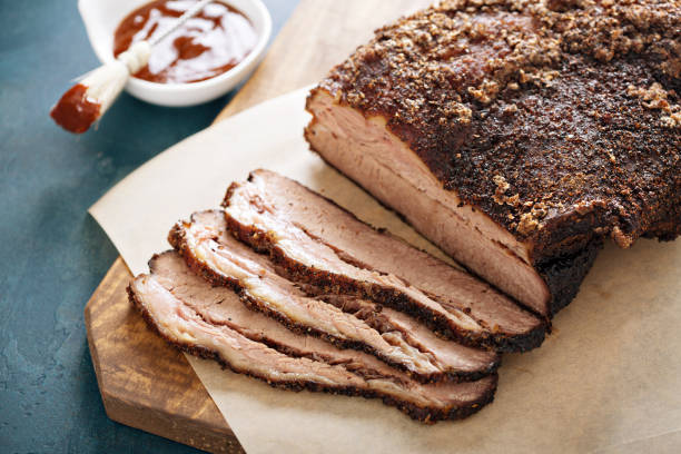 Sliced slowly cooked brisket Sliced slowly cooked brisket with bbq sauce brisket photos stock pictures, royalty-free photos & images