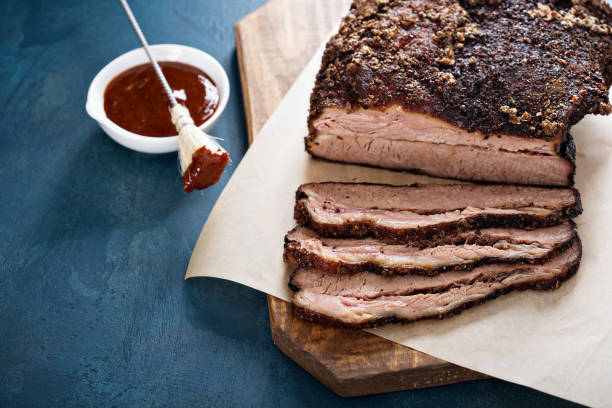 Sliced slowly cooked brisket Sliced slowly cooked brisket with bbq sauce brisket photos stock pictures, royalty-free photos & images