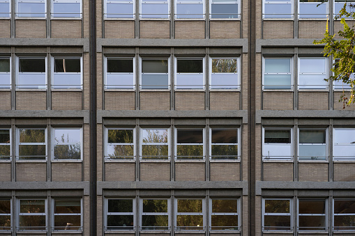 Detail of a modern building facade with various reflection in the windows
