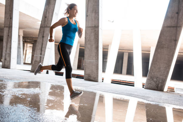 istock Female athlete running outdoors 1036911910