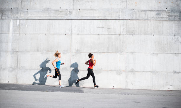 istock Two friends running together in the morning 1036911976