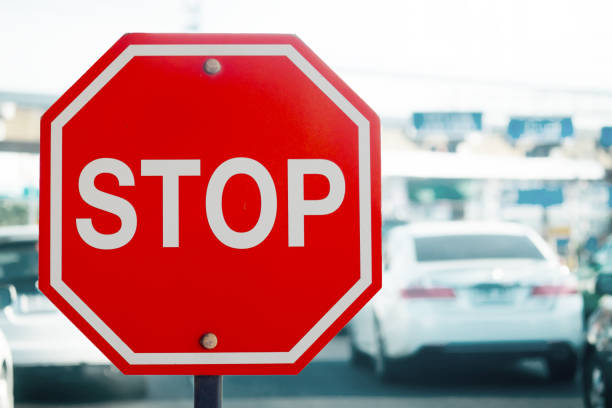 istock Stop sign post on road traffic background 1036916388