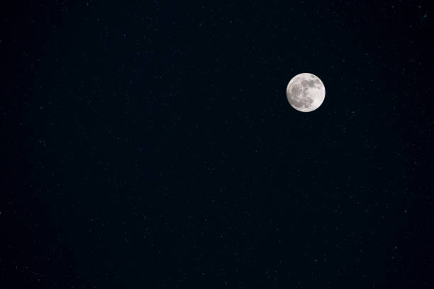 istock Full moon in night sky with shiny stars for background 1036916826