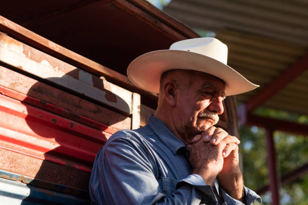 istock Senior mexican man praying with hands together 1036925690