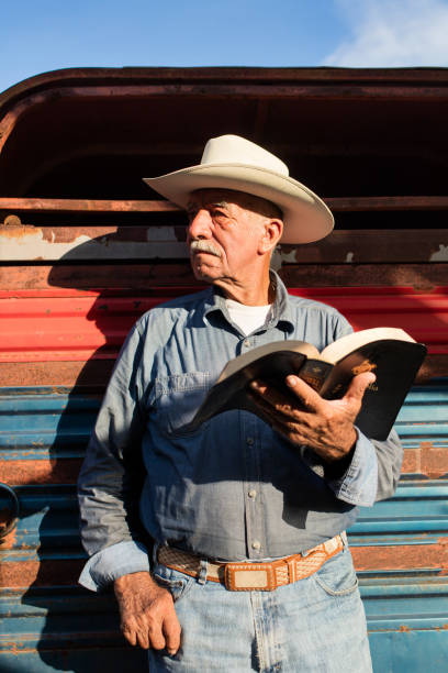 istock Senior mexican man standing with a Bible and looking away 1036925756