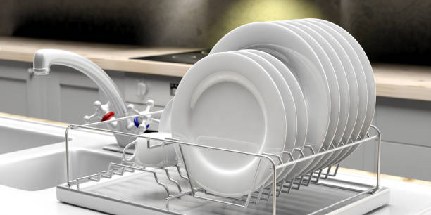 Dish drying rack with white plates on a white kitchen counter. 3d illustration Dish drying rack with white clean plates on a white kitchen sink counter. 3d illustration plate rack stock pictures, royalty-free photos & images