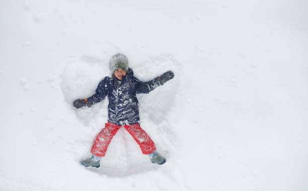 istock Boy making snow angel 1036927226