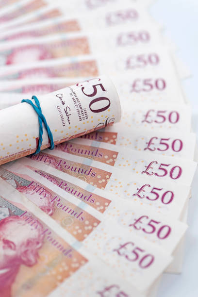 istock A roll of £50 on spread banknotes 1036956500