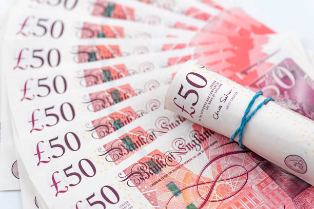 British £50 banknotes on a white background with a few of them rolled up