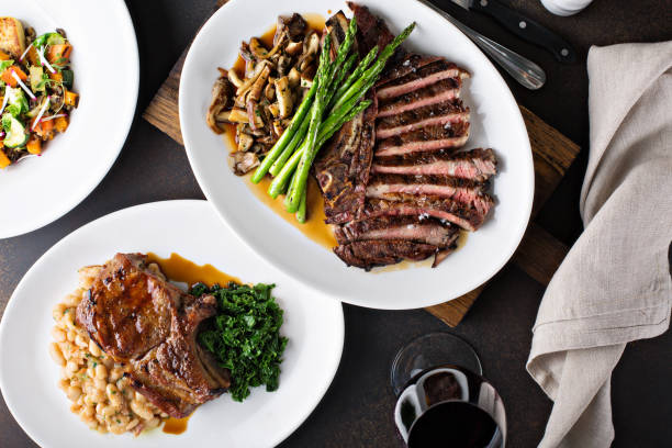 istock Overhead shot of a dinner table with steak and grilled pork 1036965662