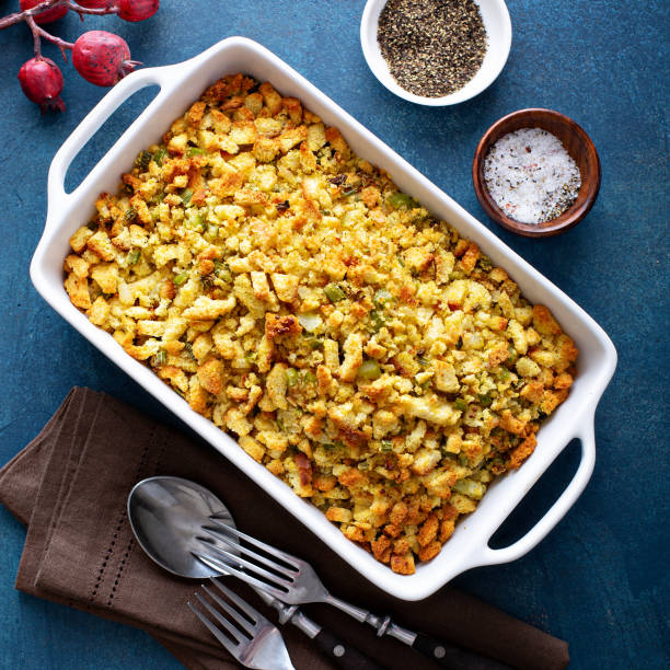 Traditional stuffing for Thanksgiving or Christmas Traditional stuffing side dish for Thanksgiving or Christmas in a baking pan stuffed stock pictures, royalty-free photos & images