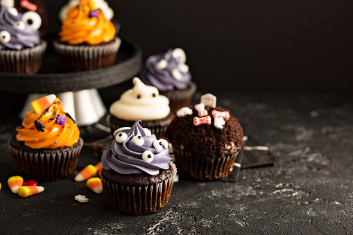 Halloween cupcakes with variety of spooky decorations