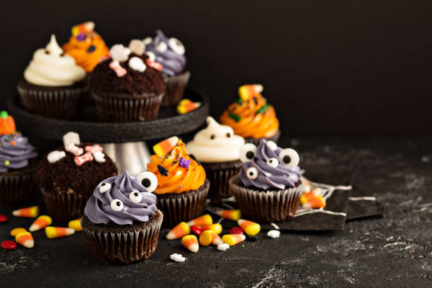 Halloween cupcakes with decorations Halloween cupcakes with variety of spooky decorations halloween cupcake stock pictures, royalty-free photos & images