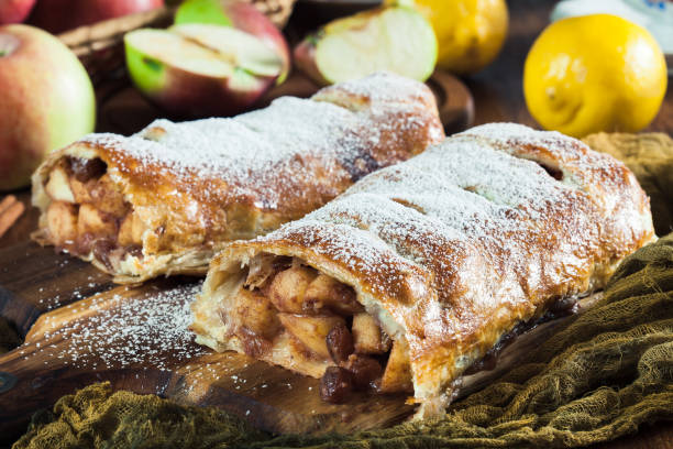 Traditional puff pastry strudel with apple Traditional puff pastry strudel with apple, raisins and cinnamon apple strudel stock pictures, royalty-free photos & images