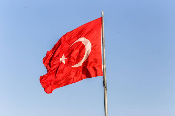 istock Turkish flag on a background of blue sky close-up 1036985132