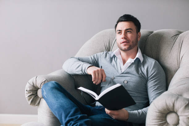 istock Handsome man sitting in an armchair and thinking 1036989658